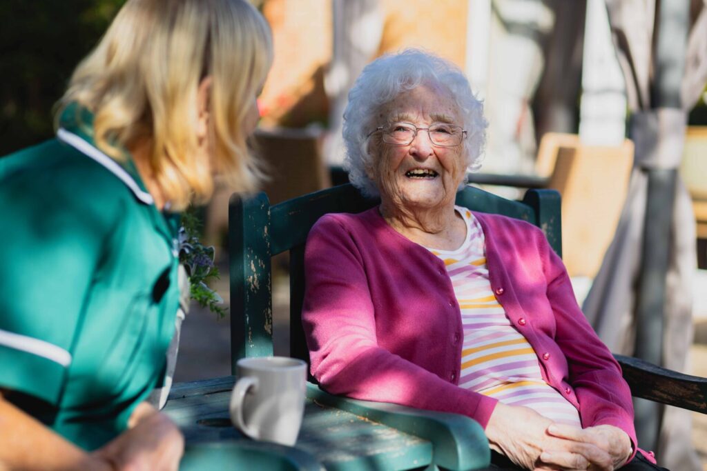 Lady resident chatting with carer